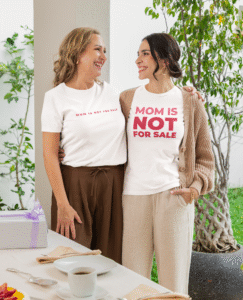 Two women hugging and celebrating mothers.